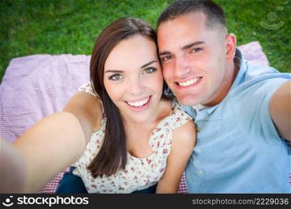 Happy Young Caucasian Couple Shooting Selfie in the Park.