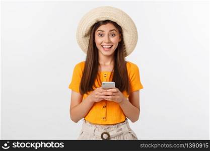 Happy young caucasian woman using smartphone standing isolated on white. Happy young caucasian woman using smartphone standing isolated on white.