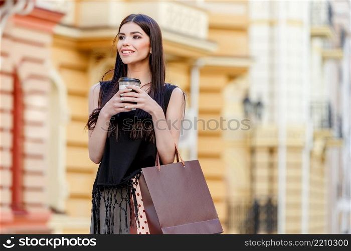 happy young caucasian woman with shopping bags outdoor. happy young woman with shopping bags