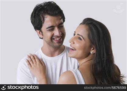 Happy young couple against white background