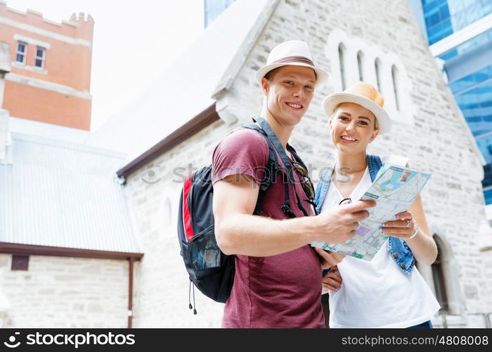 Happy young couple as tourists with a map. New places to explore