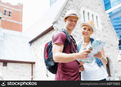 Happy young couple as tourists with a map. New places to explore