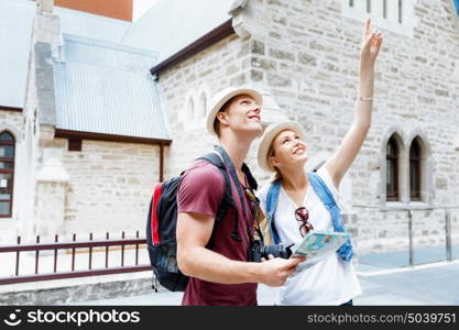 Happy young couple as tourists with a map. New places to explore