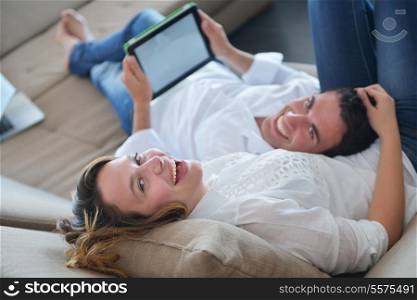 happy young couple at modern home using tablet computer