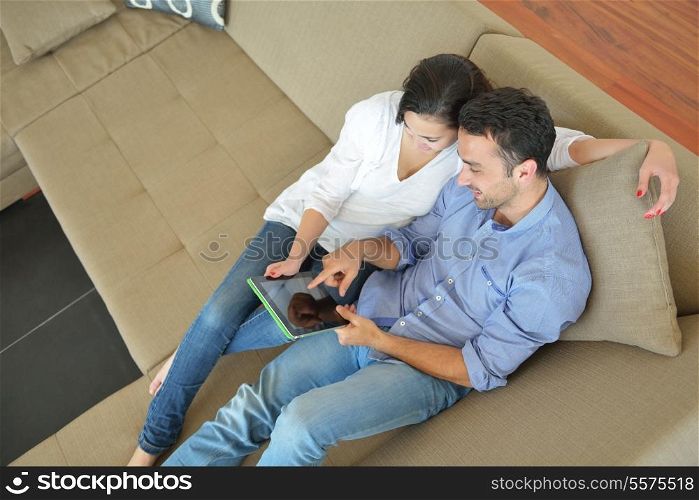happy young couple at modern home using tablet computer