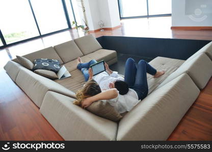 happy young couple at modern home using tablet computer