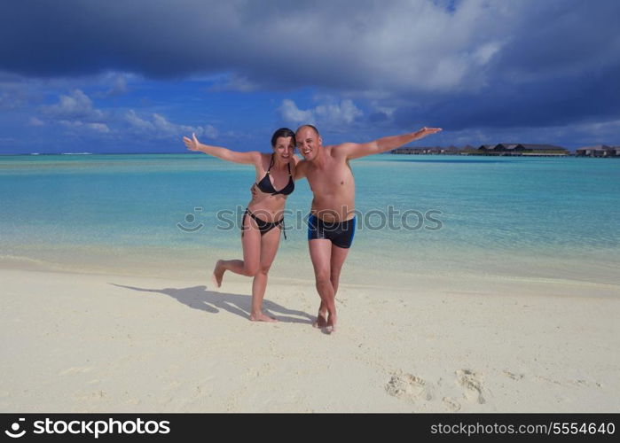 happy young couple at summer vacation have fun and relax at beautiful sunny day on beach