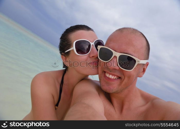 happy young couple at summer vacation have fun and relax at beautiful sunny day on beach