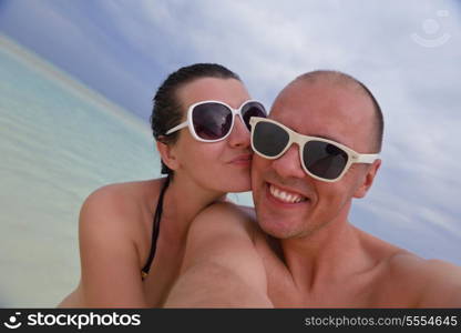 happy young couple at summer vacation have fun and relax at beautiful sunny day on beach