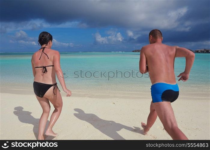 happy young couple at summer vacation have fun and relax at beautiful sunny day on beach