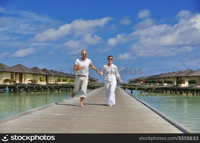 happy young couple at summer vacation have fun and relax at beautiful sunny day on beach