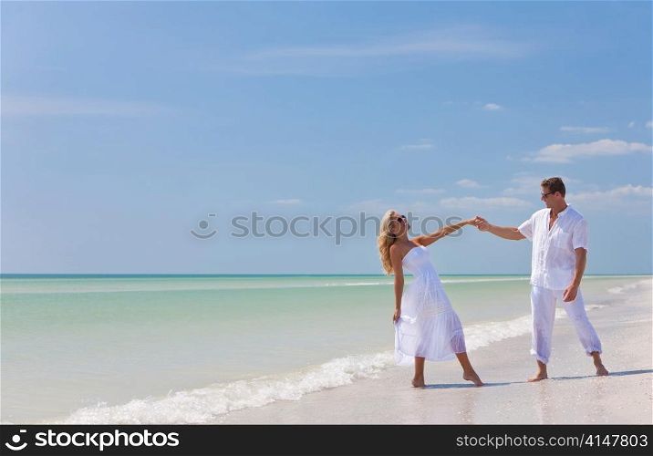Happy Young Couple Dancing Holding Hands on A Tropical Beach