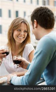 Happy Young Couple Enjoying a Glass of Wine