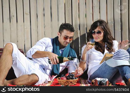 happy young couple enjoying picnic on the beach and have good time on summer vacations