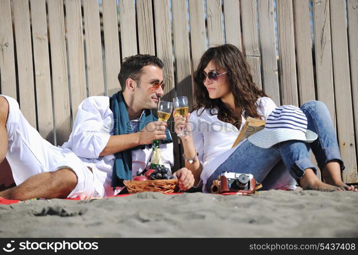 happy young couple enjoying picnic on the beach and have good time on summer vacations