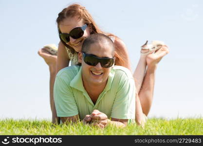 Happy young couple enjoying summer day in the park