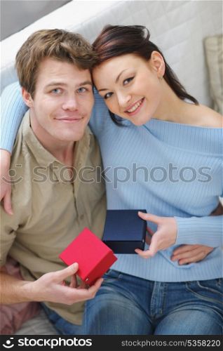 Happy young couple exchanging presents