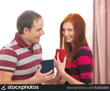 Happy young couple exchanging presents