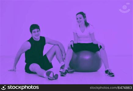 happy young couple fitness workout and fun. happy young couple fitness workout and fun at sport gym club duo tone