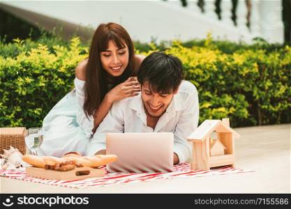 Happy young couple go picnic and dating at the park in summer.. Young couple go picnic at the park in summer.