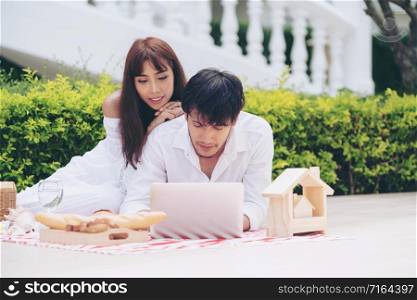 Happy young couple go picnic and dating at the park in summer.. Young couple go picnic at the park in summer.