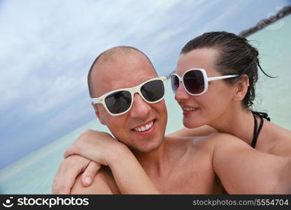 happy young couple have fun and relax at summer vacation on background maldives travel location and beautiful white sand beach