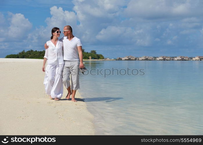 happy young couple have fun and relax at summer vacation on background maldives travel location and beautiful white sand beach