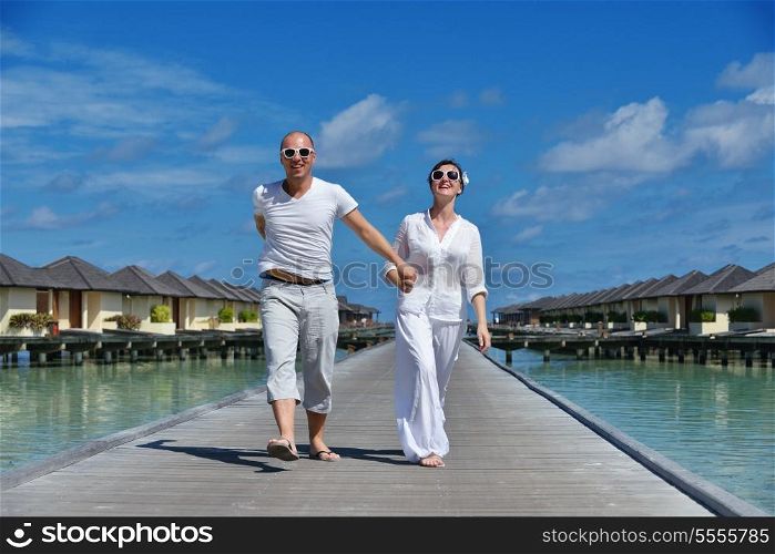 happy young couple have fun and relax at summer vacation on background maldives travel location and beautiful white sand beach