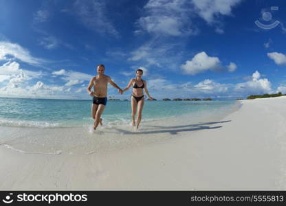 happy young couple have fun and relax at summer vacation on background maldives travel location and beautiful white sand beach