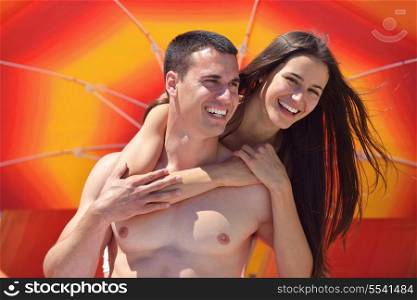 happy young couple have fun and relax on the beach