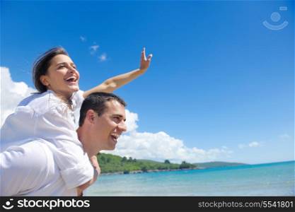 happy young couple have fun and relax on the beach