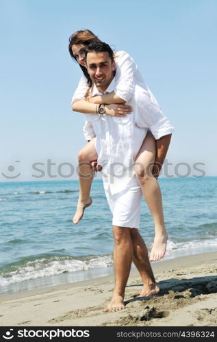 happy young couple have fun and romantic moments on beach at summer season and representing happynes and travel concept