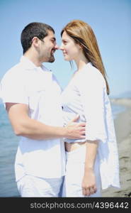 happy young couple have fun and romantic moments on beach at summer season and representing happynes and travel concept