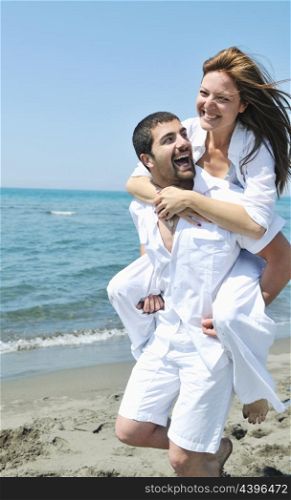 happy young couple have fun and romantic moments on beach at summer season and representing happynes and travel concept