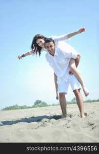 happy young couple have fun and romantic moments on beach at summer season and representing happynes and travel concept