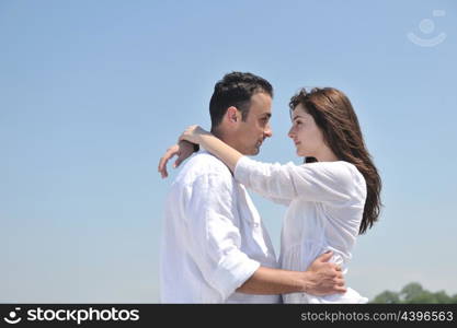 happy young couple have fun and romantic moments on beach at summer season and representing happynes and travel concept