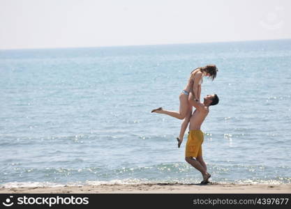 happy young couple have fun and romantic moments on beach at summer season and representing happynes and travel concept