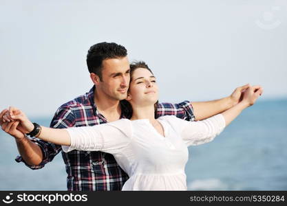 happy young couple have fun and romantic moments on beach at summer season and representing happynes and travel concept