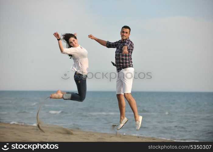 happy young couple have fun and romantic moments on beach at summer season and representing happynes and travel concept