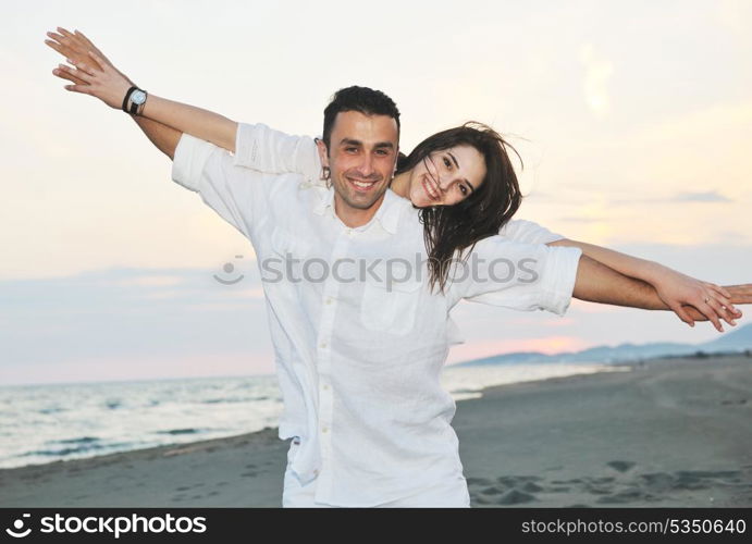 happy young couple have fun and romantic moments on beach at summer season and representing happynes and travel concept