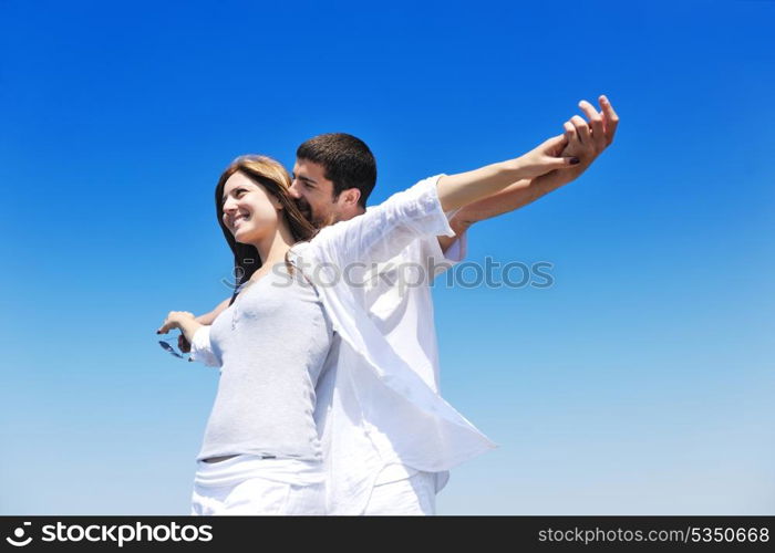 happy young couple have fun and romantic moments on beach at summer season and representing happynes and travel concept