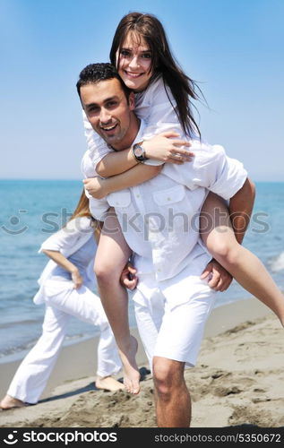 happy young couple have fun and romantic moments on beach at summer season and representing happynes and travel concept