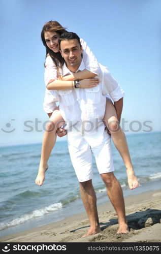 happy young couple have fun and romantic moments on beach at summer season and representing happynes and travel concept