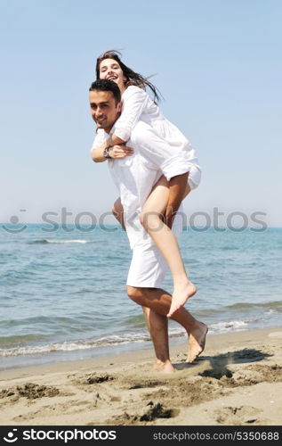 happy young couple have fun and romantic moments on beach at summer season and representing happynes and travel concept