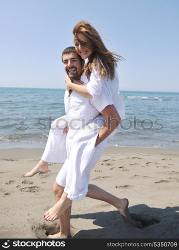 happy young couple have fun and romantic moments on beach at summer season and representing happynes and travel concept