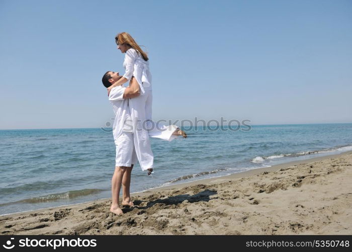 happy young couple have fun and romantic moments on beach at summer season and representing happynes and travel concept