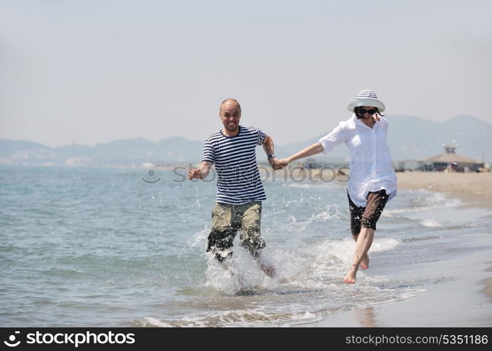 happy young couple have fun and romantic moments on beach at summer season and representing happynes and travel concept