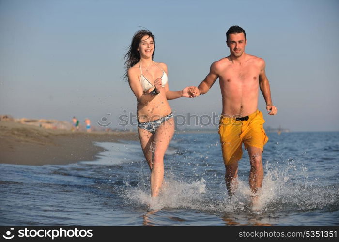 happy young couple have fun and romantic moments on beach at summer season and representing happynes and travel concept