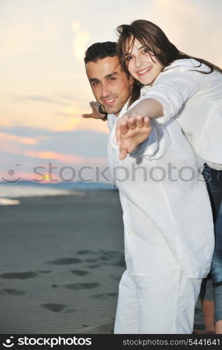 happy young couple have fun and romantic moments on beach at summer season and representing happynes and travel concept