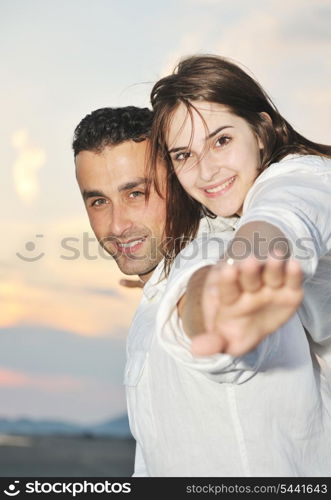 happy young couple have fun and romantic moments on beach at summer season and representing happynes and travel concept